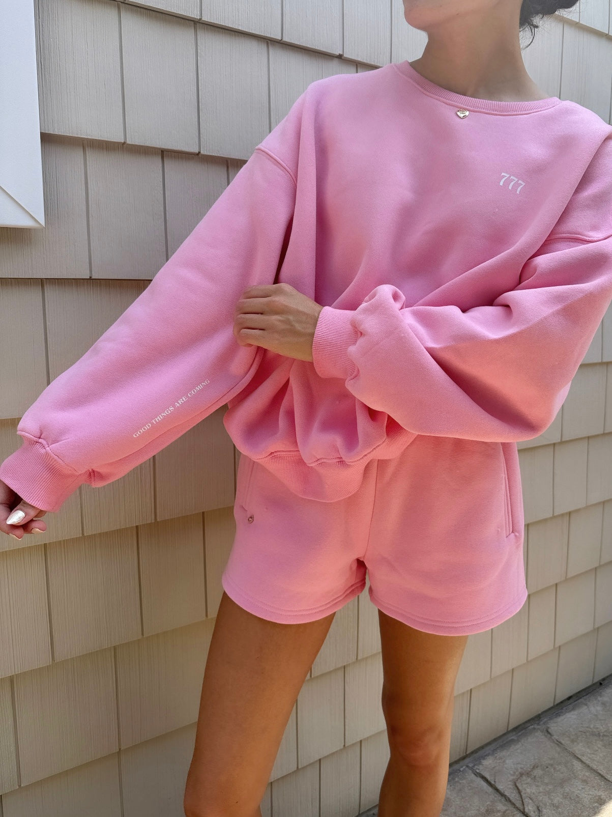 pink "good things are coming" crewneck with charm