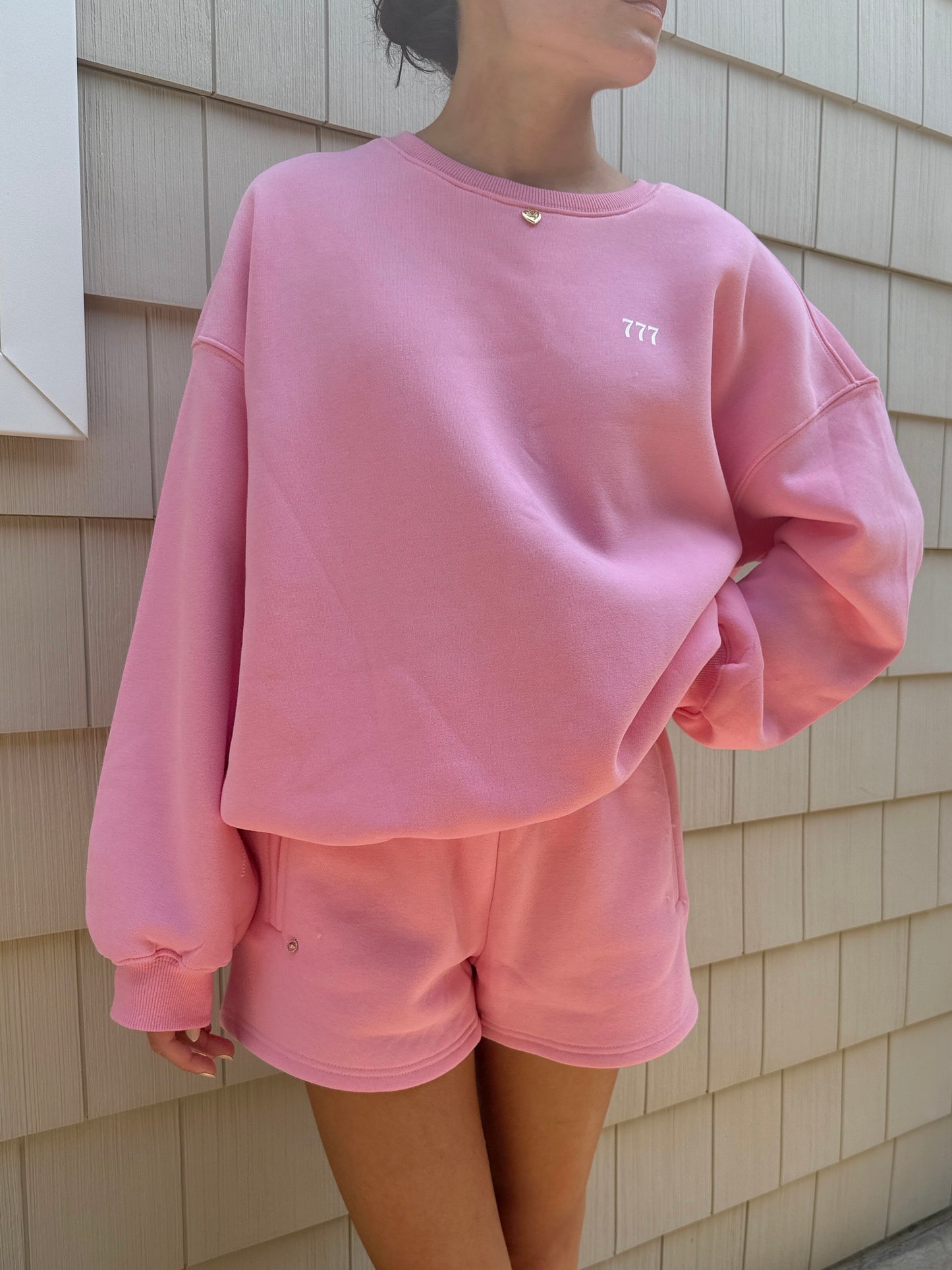 pink "good things are coming" crewneck with charm