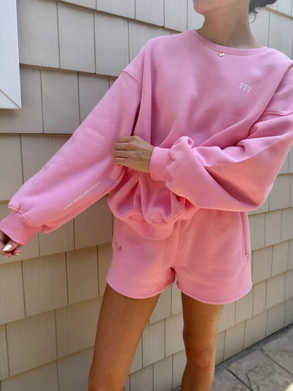 pink "good things are coming" crewneck with charm