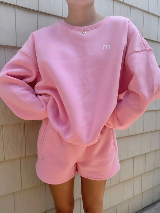 pink "good things are coming" crewneck with charm